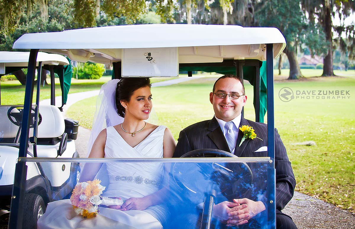 Newly Weds sitting in a golf cart.